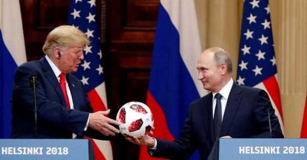 U.S. President Donald Trump receives a football from Russian President Vladimir Putin as they hold a joint news conference after their meeting in Helsinki, Finland July 16, 2018. REUTERS/Grigory Dukor