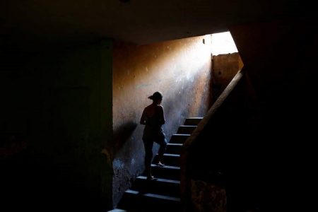 Elizabeth Altuve climbs the stairs at the occupied building where she lives in Maracaibo, Venezuela July 26, 2018. Picture taken July 26, 2018. REUTERS/Marco Bello