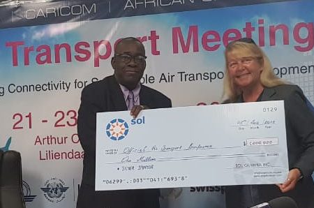 Liz Wyatt (right) of Sol Aviation Inc. handing over a cheque for $1M to Director of Marketing and Operational Support  Franklin Vieira for the upcoming ICAO Air Transport Conference.
