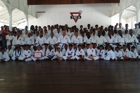 The examinees, along with their instructors and Frank Woon-A-Tai (seated centre) at last Sunday’s ASK-G grading exercise