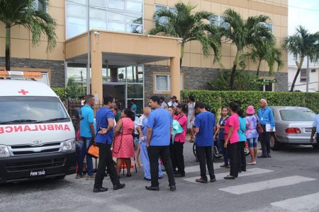 Doctors and other staff members of the Balwant Singh hospital on East Street after Tuesday's tremor led them to evacuate the building. 