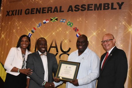GAFDD Director Marlan Cole receiving the Certificate of Accreditation in Jamaica