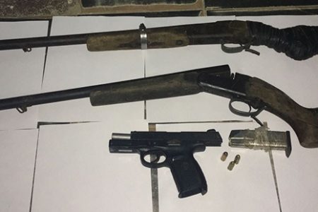 Two of the five shotguns along with the pistol and three live rounds recovered during a joint services operation at Ekura Creek.
