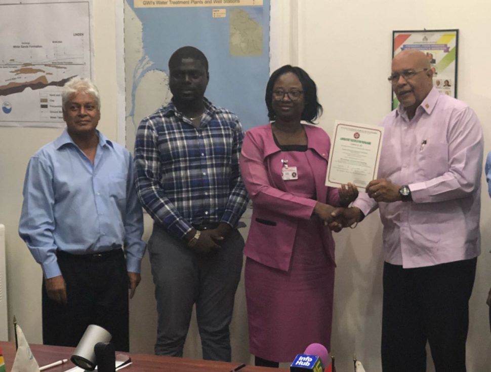From right are GWI Managing Director Dr. Richard Van West-Charles receiving the certificate from the Guyana National Bureau of Standards (GNBS) Head of Conformity Assessment Department Rodlyn Semple while Water Quality Manager Deon Anderson (second from left) and Laboratory Consultant Dr. Karamchand Ramoutar look on. 