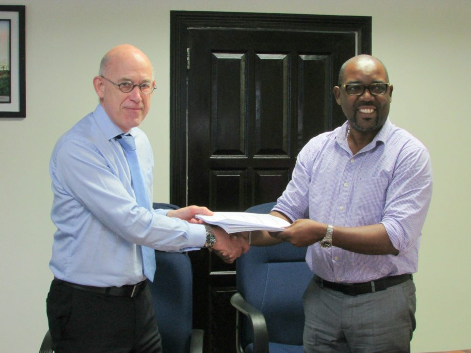 DHBC General Manager, Rawlston Adams (right) and Arie Mol of LievenseCSO (left) shaking hands following the signing of the contract in December of 2016.