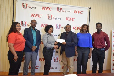 Madanna Nelson, Manager of the KFC Hinck Street Outlet, handing over the sponsorship cheque to Petra Organization Co-Director Troy Mendonca,  Also in the photo is GFF President Wayne Forde (2nd from left) and Petra staffers, Jacqueline Boodi (2nd from right) and Mark Alleyne (extreme right).