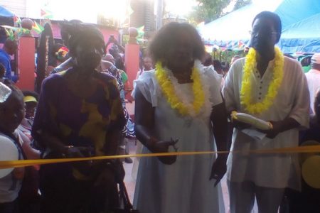 Minister Simona Broomes (at centre) cuts the ribbon to open the Buxton/Friendship Museum, Archives and Culture Centre yesterday. 