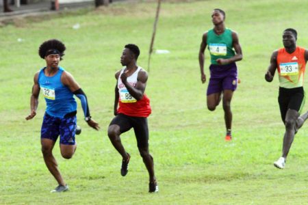 Guyana’s top 100M sprinter Emanuel Archibald (white) and Compton Caesar (blue) going at each other during the 100 dash at the ninth Boyce and Jefford Classic, Sunday in Linden. 