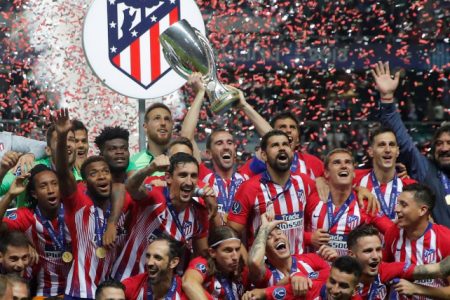 Atletico Madrid celebrates with the trophy after winning the Super Cup REUTERS/Maxim Shemetov