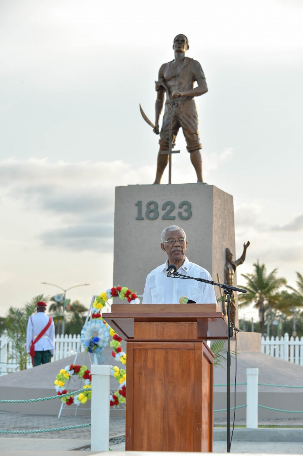 President David Granger addressing with the monument in the backdrop (Ministry of the Presidency photo)
