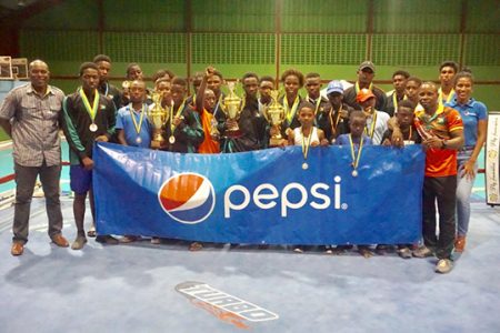 The victorious Team Guyana outfit pose with their hardware along with President of the GBA, Steve Ninvalle, Tournament Director, Sebert Blake and a representative of DDL (Pepsi brand).