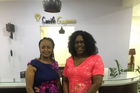 Dentist Dr. Theodora Madekurozwa, founder of Smile Guyana (left), and Junior Minister of Health, Dr. Karen Cummings at the opening of the new Smile Guyana clinic. 