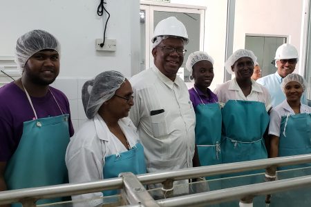 Finance Minister Winston Jordan (third from left) posing with some DDL workers.
