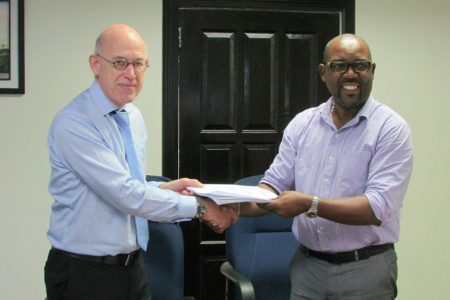 DHBC General Manager, Rawlston Adams (right) and Arie Mol of LievenseCSO (left) shaking hands following the signing of the contract in December of 2016.
