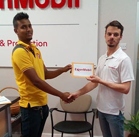 PRO of ExxonMobil, Nicholas Yearwood hands over the sponsorship to racer Raveiro Tucker (right)
