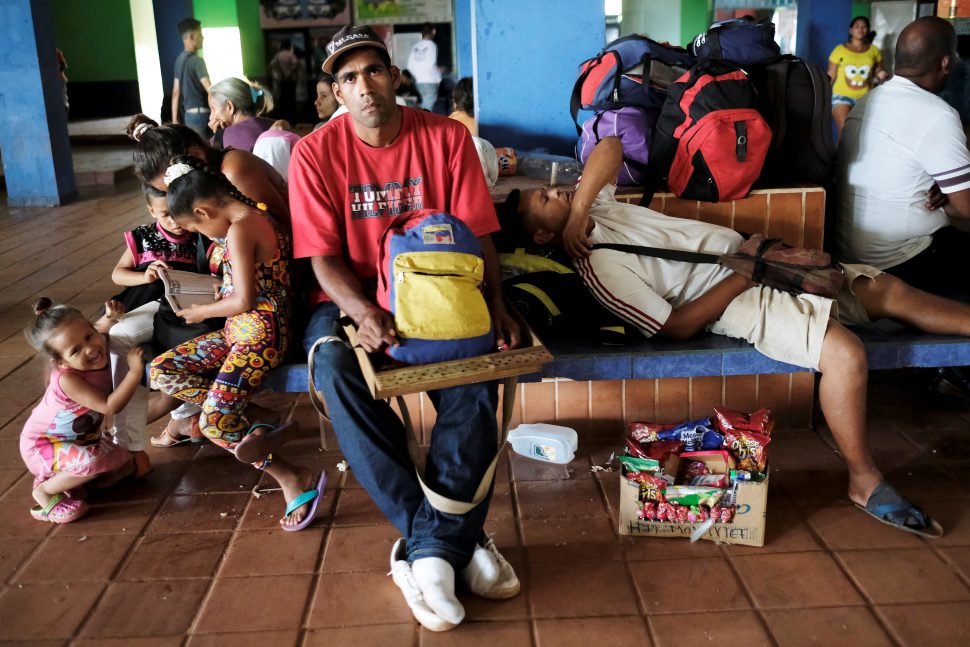 Venezuelans rest next to their belongings at a bus terminal, after being expelled from the Pacaraima border control point by Brazilian civilians, in Santa Elena, Venezuela August 19, 2018. REUTERS/Nacho Doce