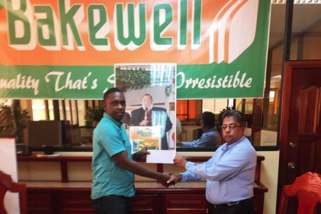 Bakewell General Manager Mr. Rajin Gang (right), handing over the sponsorship cheque Aubrey Major Jr. Director of New Era Entertainment for the Mohammed’s Enterprise/Exxon Mobile Futsal tournament.
