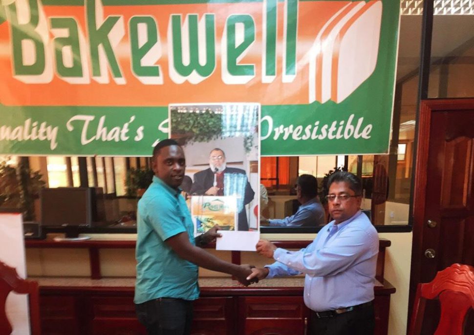 Bakewell General Manager Mr. Rajin Gang (right), handing over the sponsorship cheque Aubrey Major Jr. Director of New Era Entertainment for the Mohammed’s Enterprise/Exxon Mobile Futsal tournament.