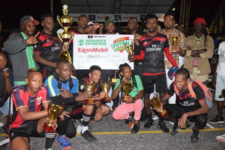 The victorious Figgy Green Jags outfit posing with their spoils after defeating German in the final of the Mohammed Enterprise/ExxonMobil Futsal Championship at the Mackenzie Sports Club (MSC) Hard-Court, Linden
