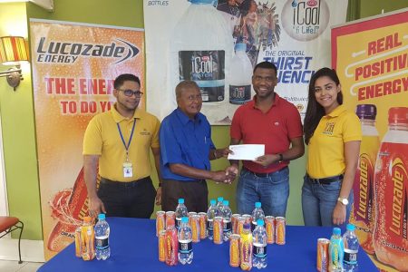 Ansa McAl’s Non-Alcoholic brand Manager Errol Nelson hands over the sponsorship to race organizer, Hassan Mohammed  in the presence of Lucozade brand manager Faris Mohamed and ICool Water Marketing Assistant Gabrielle Lopes.