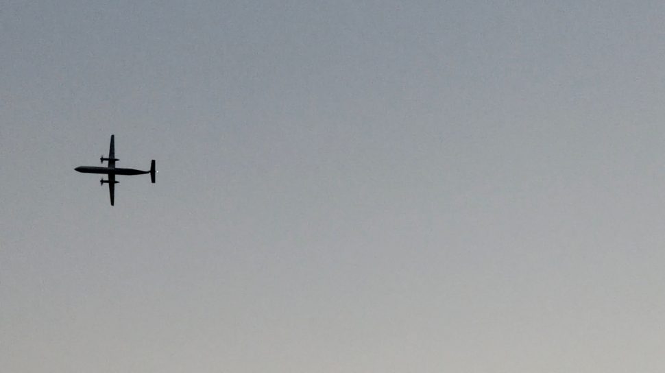 A Horizon Air Bombardier Dash 8 Q400, reported to be hijacked, flies over University Place, Washington, the U.S., before crashing in the South Puget Sound, August 10, 2018 in this still image taken from a video obtained from social media. John Waldron/via REUTERS