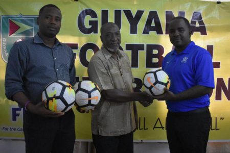 GFF’s Social Media Officer Keeran Williams (right) hands over the donation to GFA-IMC Competitions Committee member Akram Sabree (center), in the presence of IMC Chairman Trevor Williams