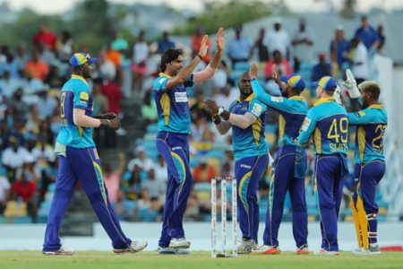 Mohammad Irfan of the Barbados Tridents celebrates with teammates during the Hero Caribbean Premier League match between Barbados Tridents and St Kitts & Nevis Patriots at Kensington Oval on Saturday in Bridgetown, Barbados. (Photo by Ashley Allen - CPL T20/Getty Images)
