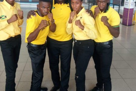 Caption Team Jamaica’s contingent (four boxers and coach) pose for a photo yesterday before boarding a flight to Guyana at the Norman Manley International Airport. 
