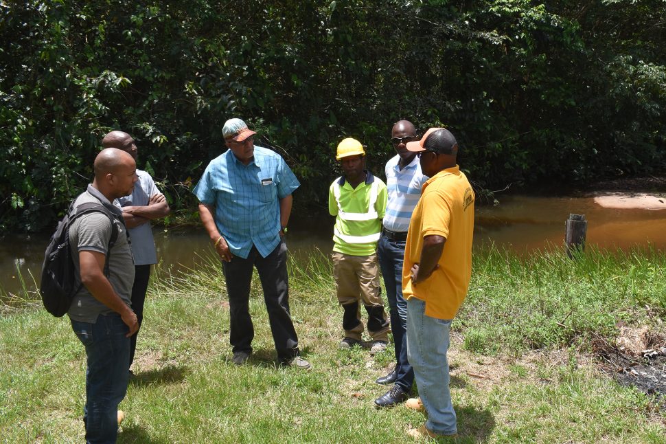 GWI and KUI officials at the Kwakwani Creek (GWI photo)