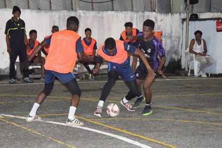 Action in the quarterfinal round between Progressive Ballers and Germans at the Mackenzie Sports Club (MSC) HardCourt in Linden in the Mohamed’s Enterprise/ExxonMobil Futsal Tournament.