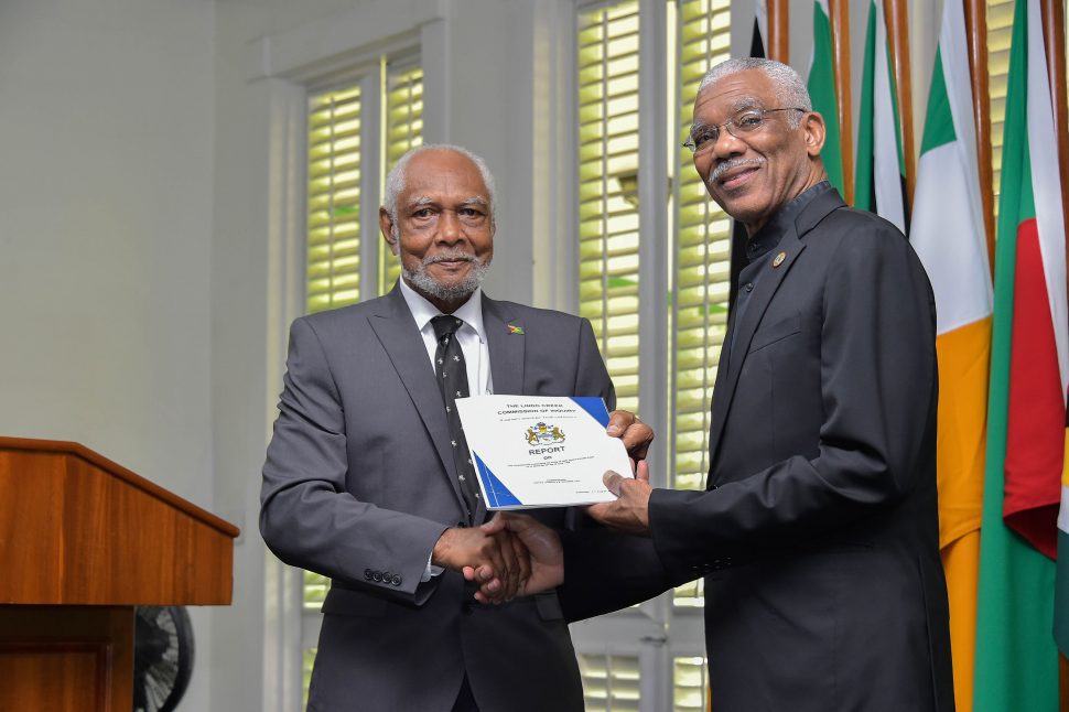 President David Granger (right) receiving the report from retired Justice Donald Trotman (Ministry of the Presidency photo)
