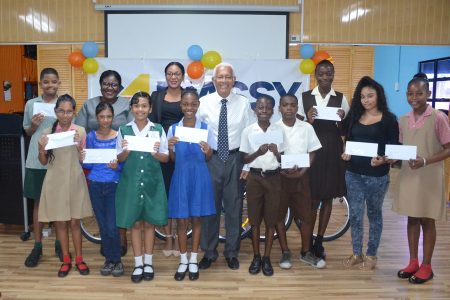 Deo Persaud (centre), Country Manager -  Massy Guyana poses with the students and other executives of the Group.