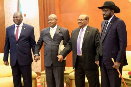 Sudan’s President Omar Al Bashir (second from right) hold hands with Uganda’s President Yoweri Museveni (third from right) , South Sudan’s President Salva Kiir (right) and South Sudan rebel leader Riek Machar during a South Sudan peace meeting as part of talks to negotiate an end to a civil war that broke out in 2013, in Khartoum, Sudan June 25, 2018. Photo - Reuters/Mohamed Nureldin Abdallah/File