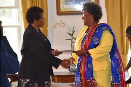 Prime Minister Mia Mottley (right) receiving the instrument of office from Governor General Dame Sandra Mason.