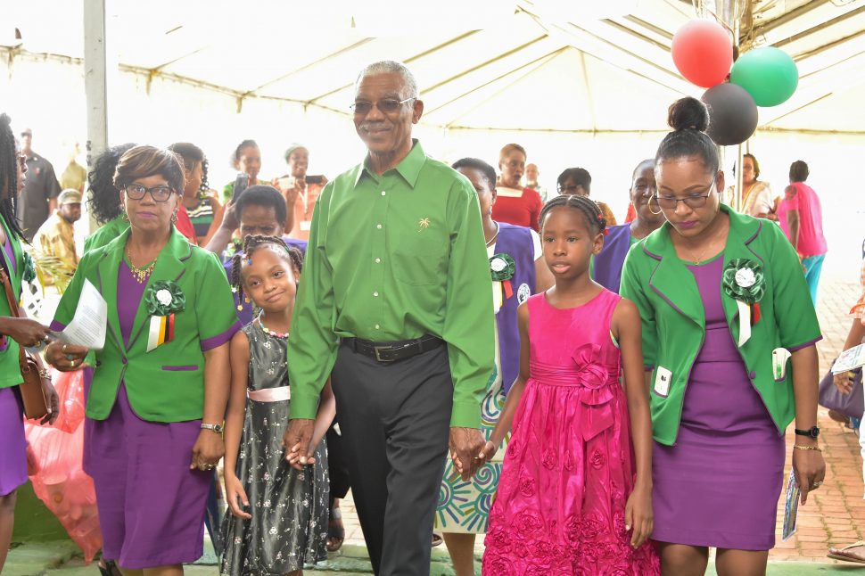 President David Granger being escorted into the opening of the National Congress of Women’s 20th Biennial Convention at Sophia yesterday. (Ministry of the Presidency photo)
