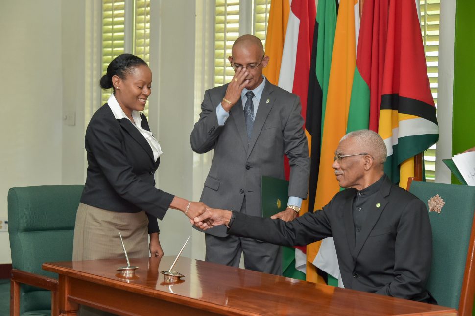 New Registrar of the Public Service Appellate Tribunal Petronilla Browne-Stewart shakes hands with President David Granger during her swearing in yesterday. See page 18. (Ministry of the Presidency photo) 