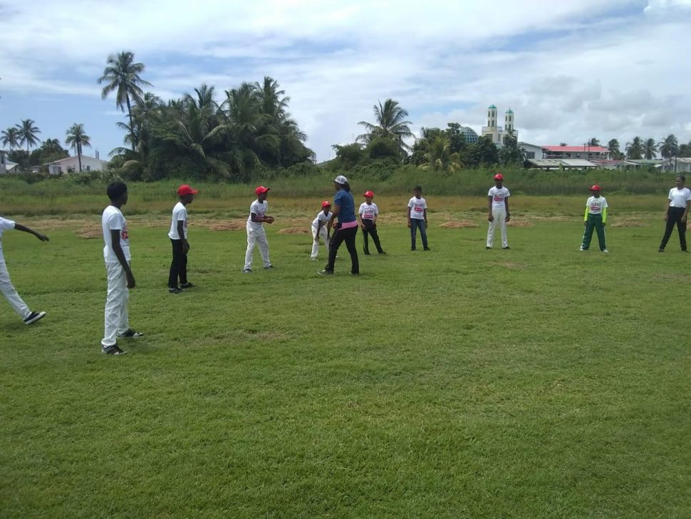 Female national player Heema Singh going through some catching practice with the kids.