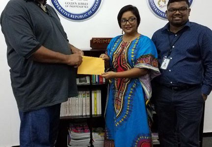 Anisha Ramzan of the Office of the Prime Minister hands over the donation to RHTYSC Secretary/CEO Hilbert Foster.
