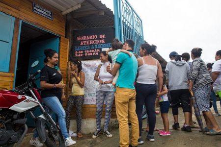 People line up outside the Centro Piloto office seeking information about school enrollment for undocumented Venezuelan children in Cúcuta, Colombia on April 4, 2018.