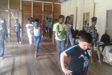 Children involved in a dance routine during the workshop.
