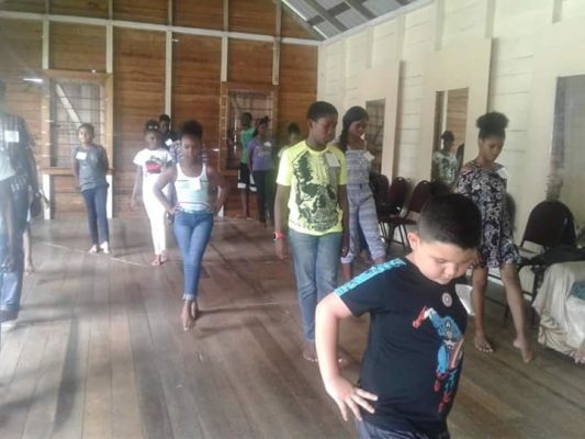 Children involved in a dance routine during the workshop.
