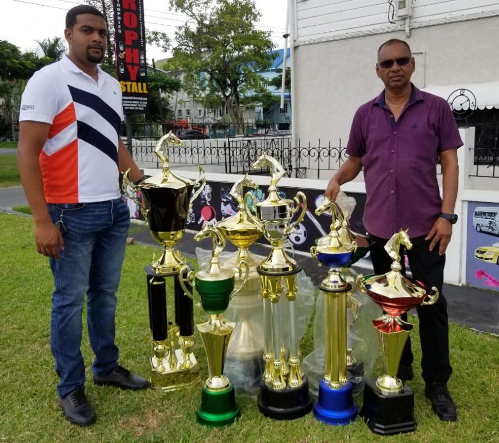 Ramesh Sunich (right) and Nazrudeen ‘Junior’ Mohamed of the organising committee display the trophies sponsored by the Trophy Stall.
