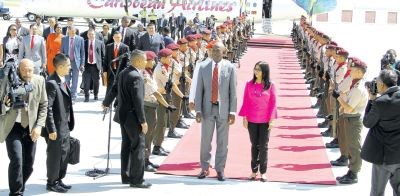 Prime Minister Dr Keith Rowley walks past the Guard of Honour on his arrival in Caracas, Venezuela, yesterday.