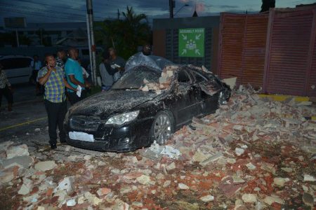 A car which was destroyed after piece of the wall from Roxy Pizza Hut fell on it yesterday after a 6.8 magnitude earthquake.