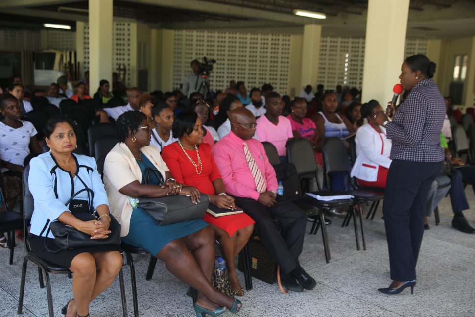 Minister of Education Nicolette Henry addressing parents, teachers and education officers at a meeting held at Queen’s College yesterday. 