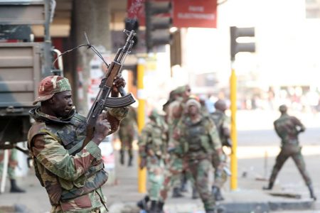 Soldiers walk through the streets of Harare (Reuters)