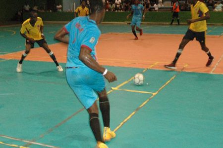 Wesley Greenidge of Back Circle attempting a pass against Tiger Bay during their semi-final matchup in the GT Beer ‘Keep Ya Five Alive’ Futsal Championship at the National Gymnasium
