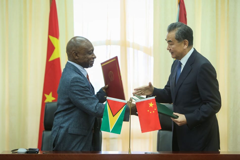 Minister of Foreign Affairs Carl Greenidge exchanges pleasantries with China’s State Councilor and Minister of Foreign Affairs Wang Yi after the signing of the two agreements yesterday. (Photo by Terrence Thompson) 