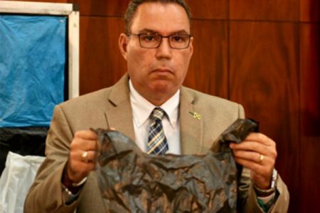 Daryl Vaz, Jamaica Minister without Portfolio in the Ministry of Economic Growth and Job Creation displays a plastic shopping bag at a press conference at the Office of the Prime Minister in St Andrew on Monday, September 17, 2019. (JAMAICA GLEANER)