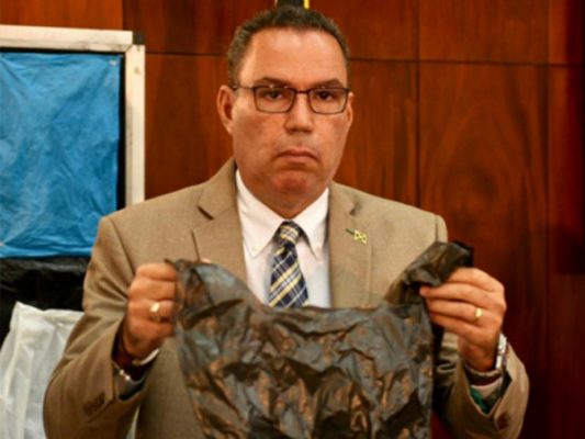 Daryl Vaz, Jamaica Minister without Portfolio in the Ministry of Economic Growth and Job Creation displays a plastic shopping bag at a press conference at the Office of the Prime Minister in St Andrew on Monday, September 17, 2019. (JAMAICA GLEANER)